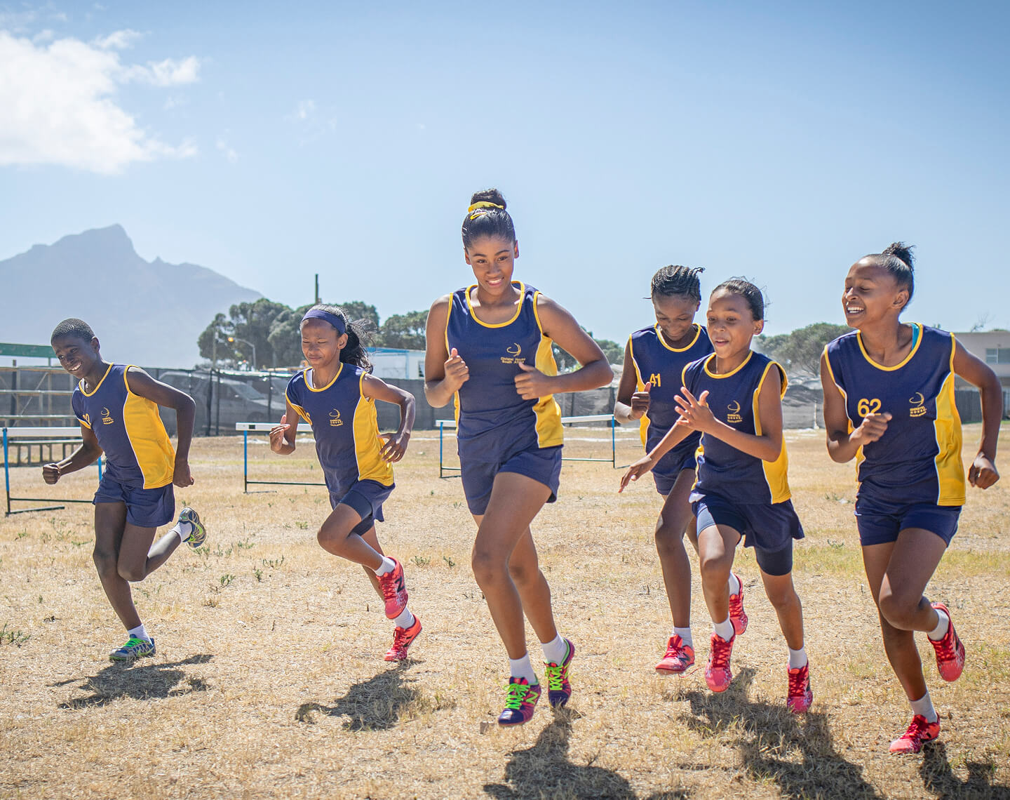 Christel House students running together on a field